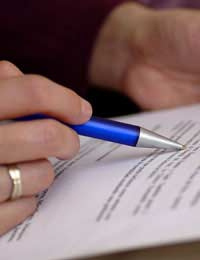 A picture of a person examining text to support an article about business letters and sales proposal writing skills.