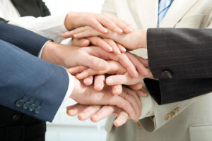 A picture of a group handshake to support a page about sales team building.