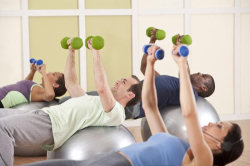 Picture of people exercising in a gym to illustrate an article about sales training exercises.